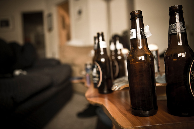 Varias botellas de cerveza vacías en una mesa de café.